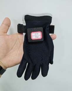 The glove in hand — soft textile with a compact electronics module